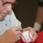 WWII vet signs ball.