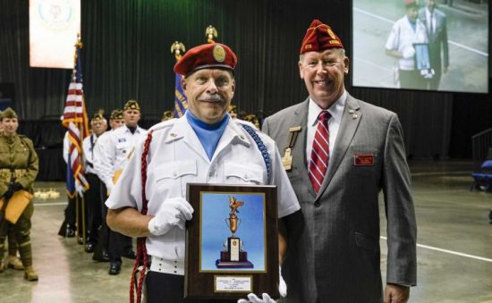 A representative from Sons of The American Legion Squadron 457 (Detachment of New York) poses for a photograph with National Commander Brett Reistad following their class victory during the Color Guard Competition at the 101st American Legion National Convention Friday, August 23, 2019 in Indianapolis.